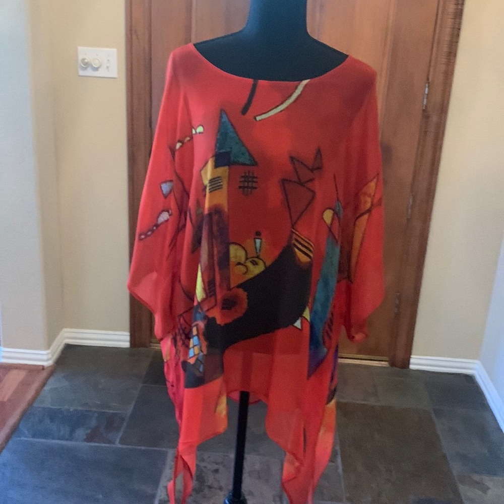 Stunning red poncho with geometric print down front & back. One size fits most.